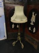 A heavy and ornate adjustable standard lamp
