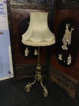 A heavy and ornate adjustable standard lamp