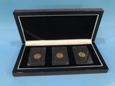 Three gold half sovereigns, 1911, 1912, 1913, in display case