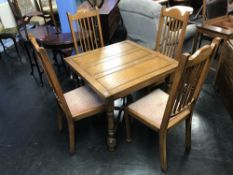 Oak drawer leaf table and four chairs