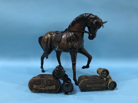 A leather horse and two pairs of opera glasses