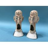 A pair of Continental porcelain match strikers, 'Wide Eyed and Open Mouthed'