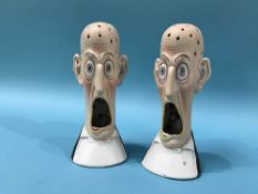 A pair of Continental porcelain match strikers, 'Wide Eyed and Open Mouthed'