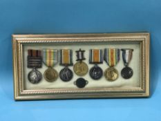 Framed and mounted collection of World War I and Boer war medals and two others, dog tag to Sapper