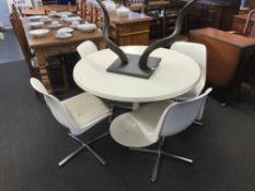 A 'Tulip' dining table and four revolving dining chairs