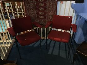 A pair of carver chairs designed by Fritz Hansen, on square metal framework and red upholstery