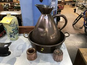 A large copper measure, (four gallons), a circular two handled pan and two jelly moulds