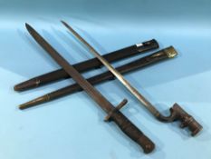 Two bayonets with leather scabbards