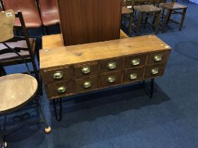 A set of ten filing drawers on later stand, W 102cm