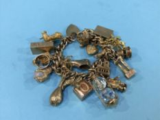 A 9ct bracelet with various 9ct charms etc, 107g total weight