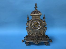 An ornate eight day metalwork clock