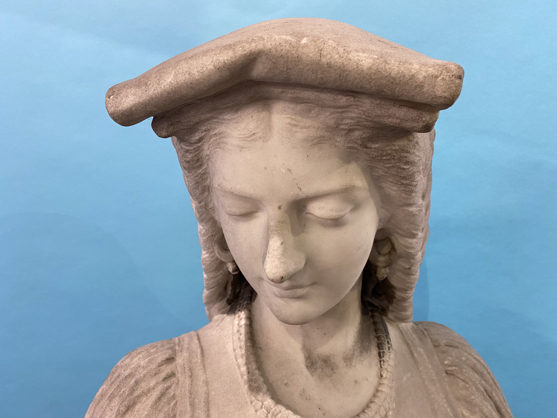 A 19th century quarter length marble bust of a lady, wearing a headdress and cross, resting upon a - Image 5 of 14