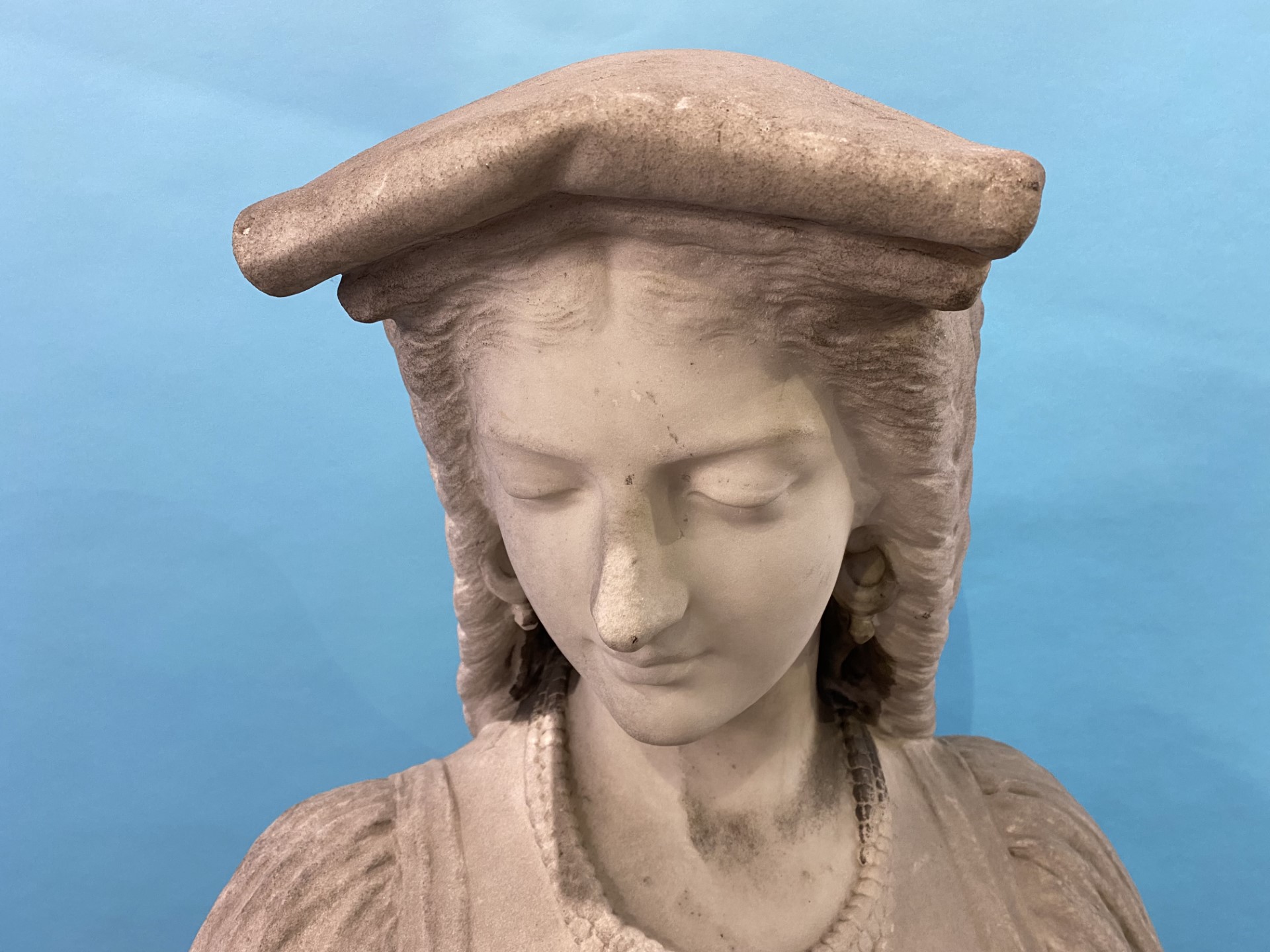 A 19th century quarter length marble bust of a lady, wearing a headdress and cross, resting upon a - Image 6 of 14