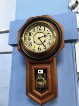 A walnut octagonal cased wall clock