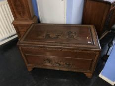 An Oriental carved camphorwood chest, W 100cm