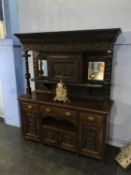 A large and heavily carved oak mirror back sideboard