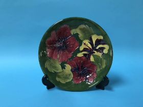 A Moorcroft circular wall plate decorated with Irises, D 26cm