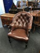 A Victorian mahogany button back brown leather armchair