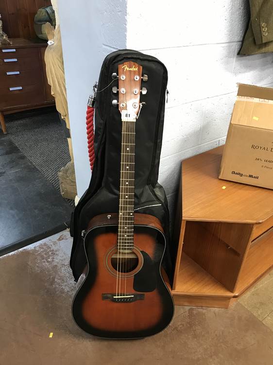 A fender acoustic guitar and case