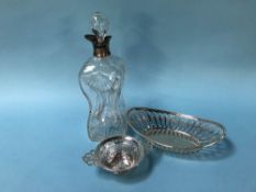 A silver rimmed cut glass dimple decanter and two silver baskets