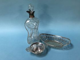 A silver rimmed cut glass dimple decanter and two silver baskets