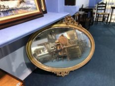 A 20th Century gilt ornate oval mirror, 100 x 120cm