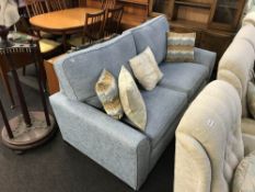 A large two seater blue bed settee