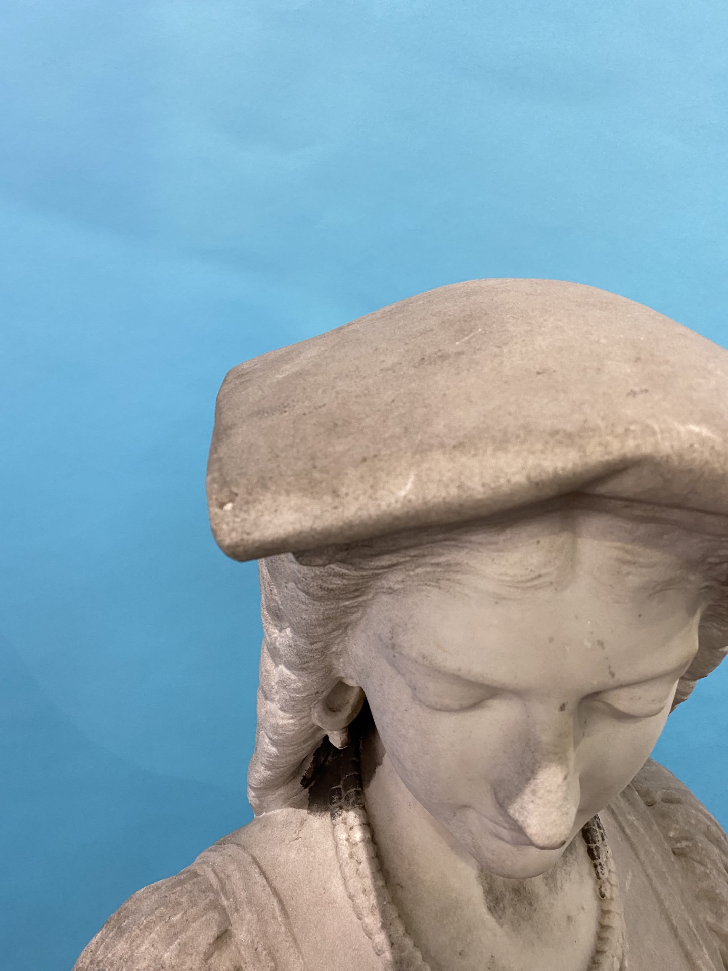 A 19th century quarter length marble bust of a lady, wearing a headdress and cross, resting upon a - Image 9 of 14