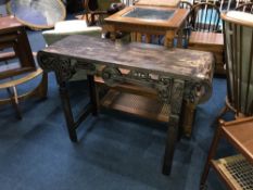 An Oriental hardwood decoratively carved side table, W 114cm