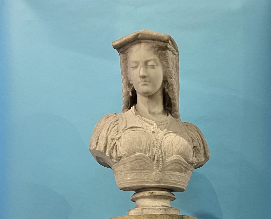 A 19th century quarter length marble bust of a lady, wearing a headdress and cross, resting upon a - Image 2 of 14