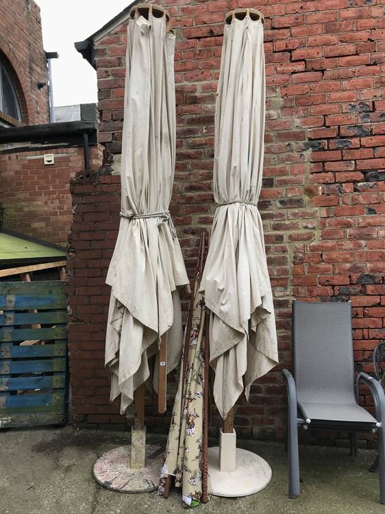 Two very large parasols and stands