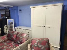 A modern cream double door wardrobe and matching chest of drawers