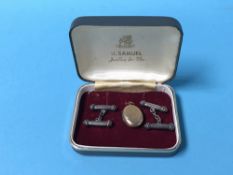 Pair of silver cufflinks and a locket