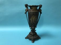 A tall ornate bronze decorative vase