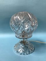 A cut glass table lamp and shade