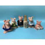 A stoneware bottle 'The Doctor's Stout' and a set of five NatWest pigs