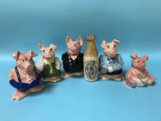 A stoneware bottle 'The Doctor's Stout' and a set of five NatWest pigs