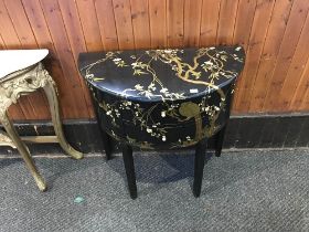 An Oriental lacquered demi-lune side cabinet, with two central drawers, flanked by two cupboard