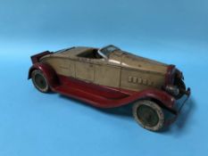 A Kingsbury Toys clockwork tin plate car, stamped 'Made in USA'