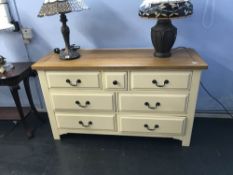 Modern oak and cream chest of seven drawers, W 135cm
