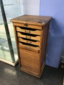A 1930s oak tambour fronted office filing cabinet, W 50cm