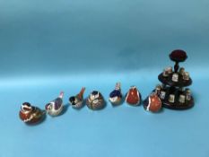 A collection of fifteen Royal Crown Derby thimbles and seven Royal Crown Derby paperweights