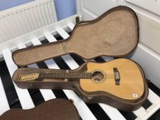 A vintage guitar, serial number VEC500-12 and case