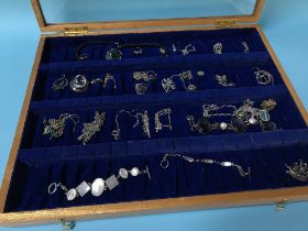 Collection of jewellery in glass top cabinet