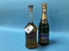 A bottle of Jack Daniels Tennessee Bicentennial whiskey and a bottle of De Venoge champagne