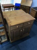 A pine two door cabinet and pine side table