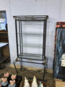 A metal display unit with three glass shelves