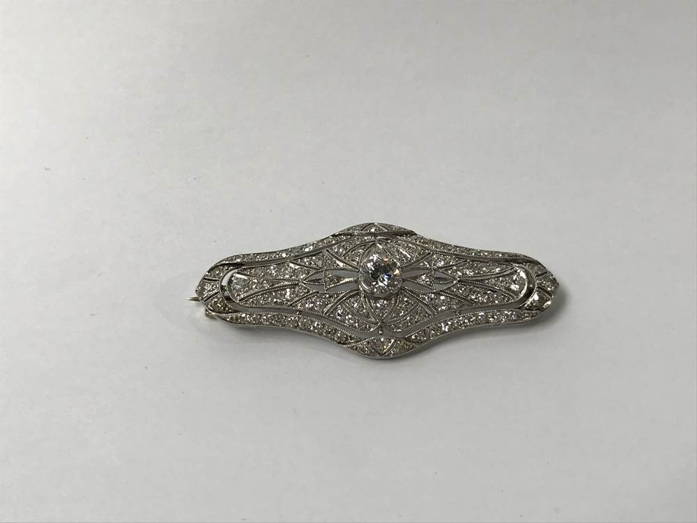 A white metal (platinum?) diamond set brooch, central diamond approx. 0.5 to 0.75ct, 49 x 20mm, 7. - Image 2 of 4