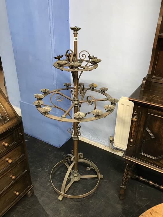 A copper two tier circular candle stand