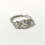 A platinum three stone diamond ring, central stone approx. 1.5ct, two on shoulder approx. 0.5ct